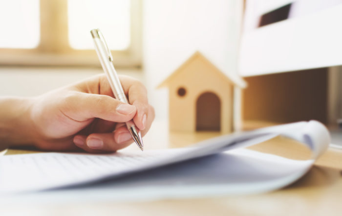 Man signing real estate document